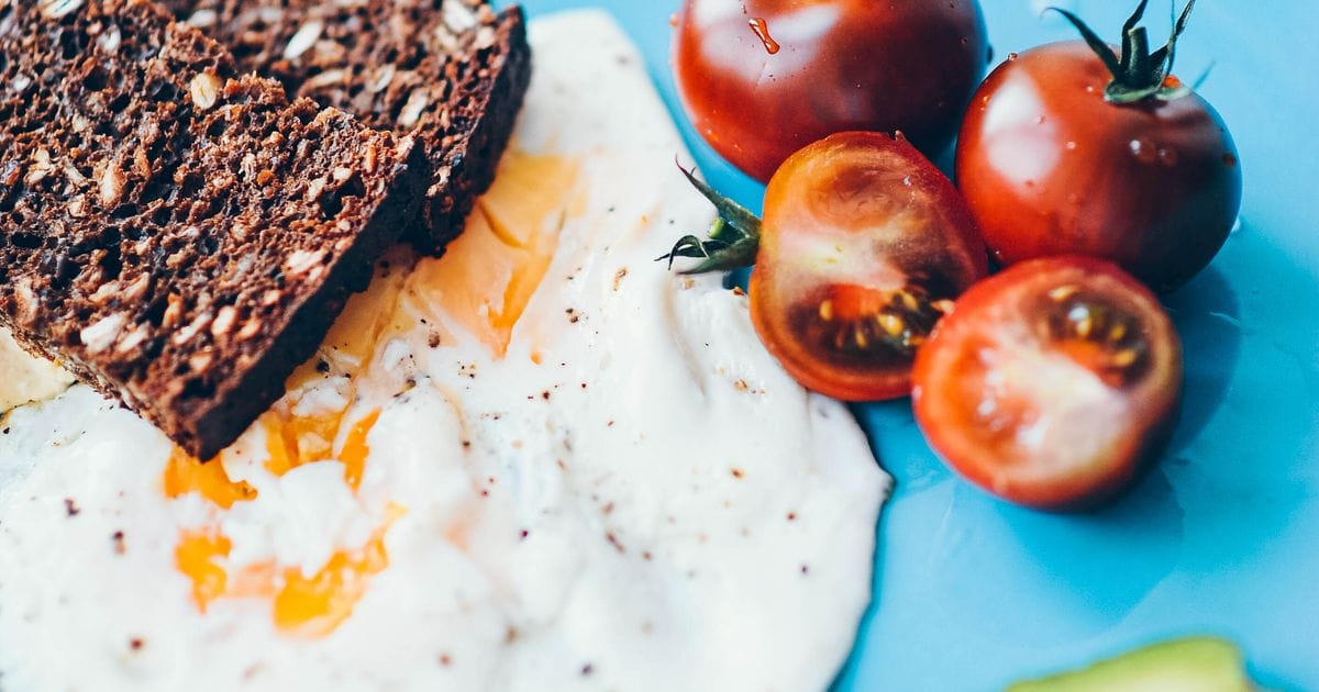 Healthy breakfast with eggs, bread and tomatoes